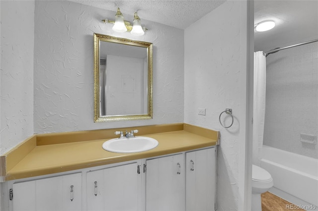 8060 E Girard Ave Unit 514, Denver, CO 80231 - bathroom featuring a textured wall, vanity, a textured ceiling, and shower / bathtub combination with curtain