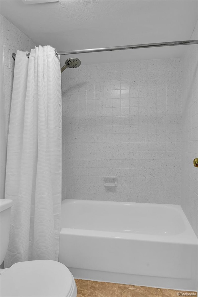 8060 E Girard Ave Unit 514, Denver, CO 80231 - bathroom featuring toilet and shower / tub combo with curtain