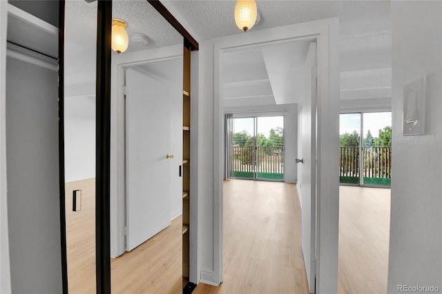 8060 E Girard Ave Unit 514, Denver, CO 80231 - hall featuring wood finished floors and a textured ceiling