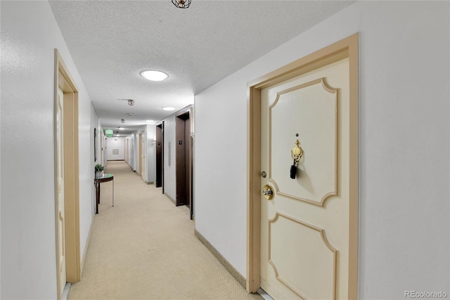 8060 E Girard Ave Unit 514, Denver, CO 80231 - hallway with light carpet, a textured ceiling, and elevator