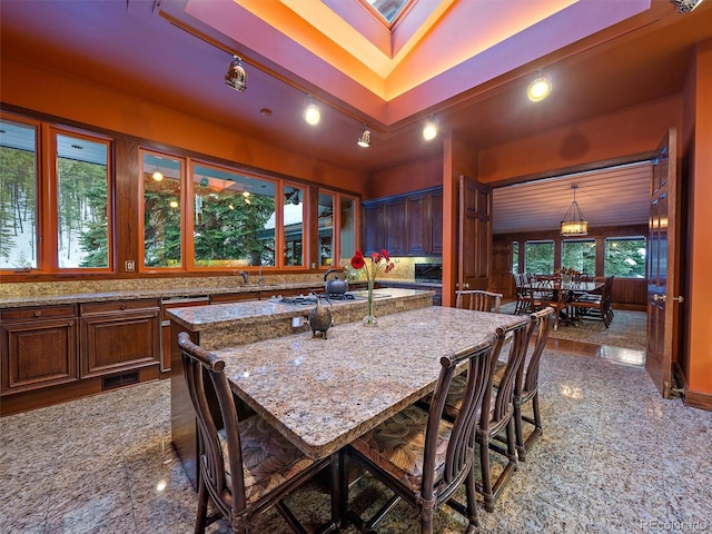 tiled dining space with a skylight