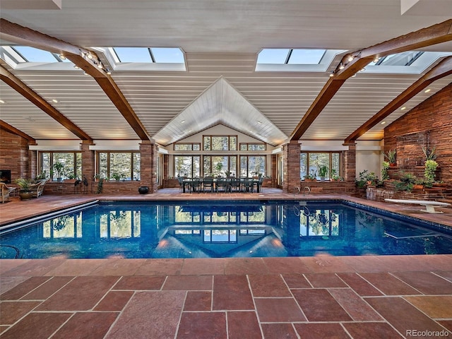 view of pool with a diving board and a skylight