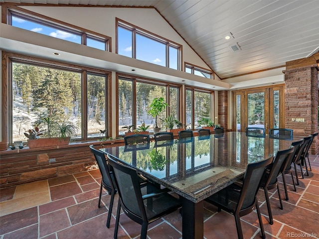 sunroom / solarium featuring vaulted ceiling and plenty of natural light