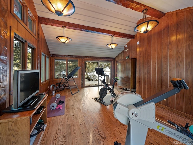 workout area with wooden walls, vaulted ceiling, and hardwood / wood-style floors