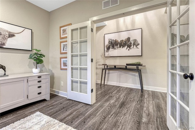 office with baseboards, visible vents, dark wood finished floors, and french doors