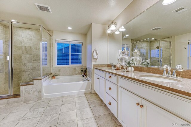 full bathroom with a garden tub, visible vents, and a sink