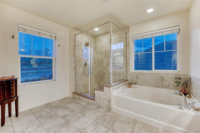 bathroom featuring a shower stall, a bath, and tile patterned floors