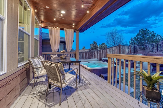 wooden deck featuring a fenced backyard and an outdoor hot tub