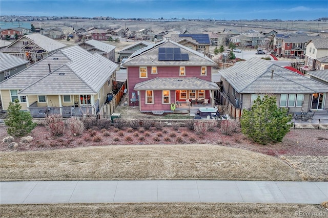 view of front of house with covered porch, a residential view, and fence