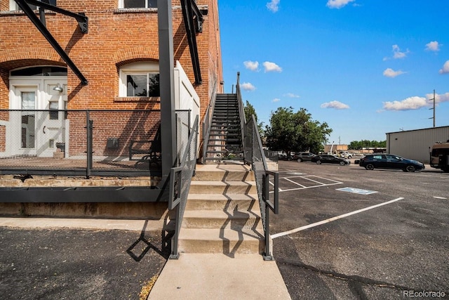 201 Lamkin St Unit 204, Pueblo, CO 81003 - view of side of home with brick siding, uncovered parking, and stairs
