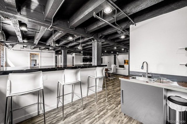 201 Lamkin St Unit 204, Pueblo, CO 81003 - kitchen with wood finished floors, a breakfast bar, and dark countertops