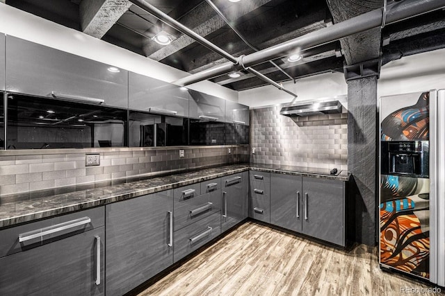 201 Lamkin St Unit 204, Pueblo, CO 81003 - kitchen featuring gray cabinetry, light wood-type flooring, tasteful backsplash, black electric cooktop, and dark stone counters