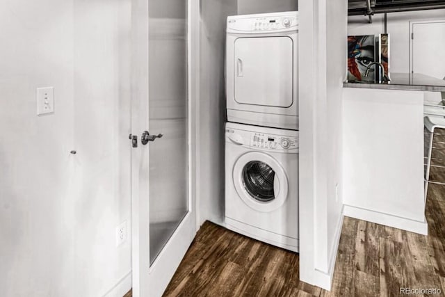 201 Lamkin St Unit 204, Pueblo, CO 81003 - laundry room with stacked washer and clothes dryer and dark wood-type flooring