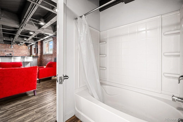 201 Lamkin St Unit 204, Pueblo, CO 81003 - bathroom featuring brick wall, shower / tub combo, and wood finished floors