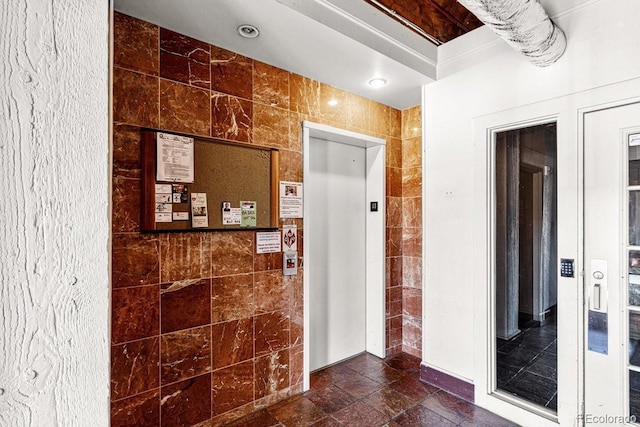 201 Lamkin St Unit 204, Pueblo, CO 81003 - hallway featuring tile walls and elevator