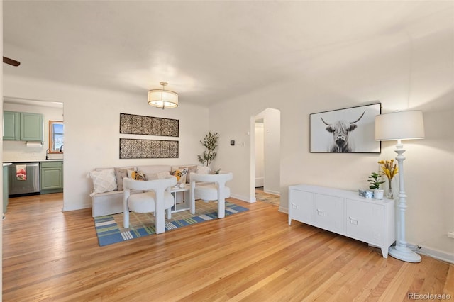 living room with light hardwood / wood-style flooring and sink