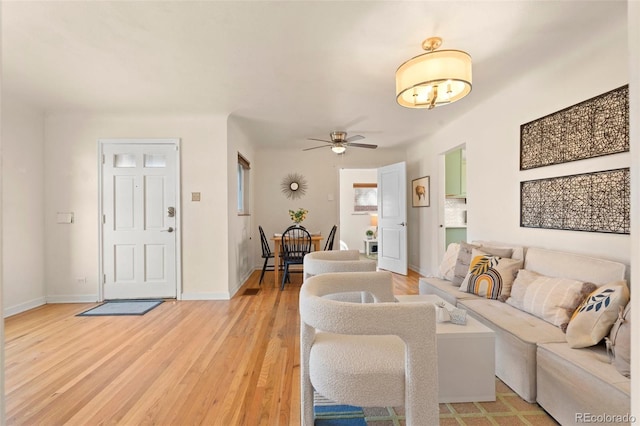 living room with light hardwood / wood-style floors and ceiling fan