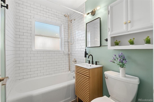 full bathroom with vanity, toilet, and tiled shower / bath