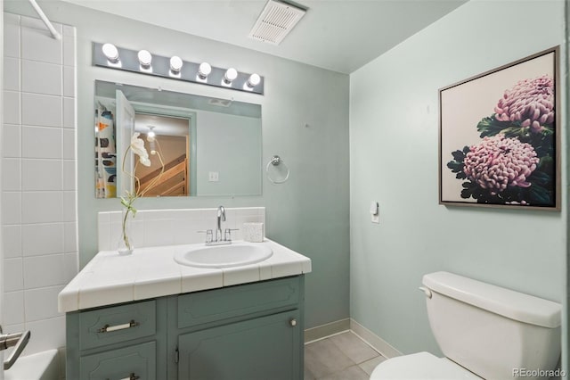 bathroom with tile patterned floors, vanity, and toilet