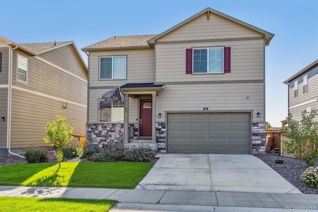 view of front of house featuring a garage, a front yard, stone siding, and driveway