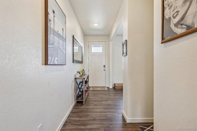 interior space featuring dark wood-style floors and baseboards