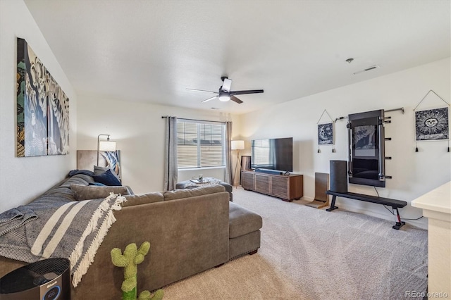 living area featuring carpet floors, visible vents, and ceiling fan