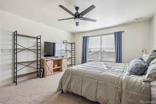 bedroom with visible vents, a ceiling fan, carpet flooring, a textured ceiling, and baseboards