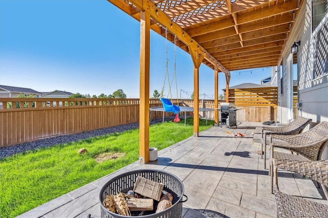 view of patio featuring an outdoor fire pit, area for grilling, and a fenced backyard