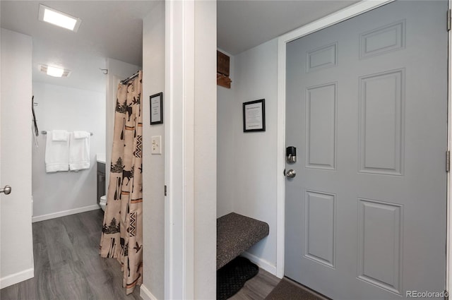 bathroom with hardwood / wood-style flooring and toilet