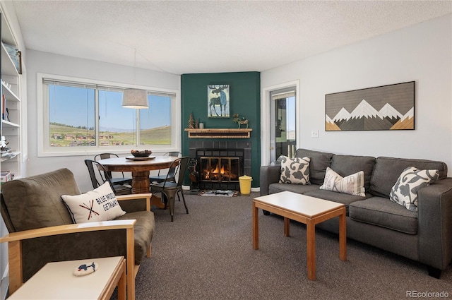 carpeted living room featuring a textured ceiling and a tiled fireplace