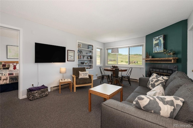 207 Lake Dr Unit 1203, Granby, CO 80446 - carpeted living area featuring built in shelves, a glass covered fireplace, baseboard heating, and baseboards