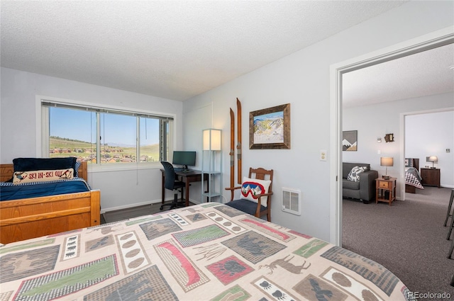 bedroom with a textured ceiling and carpet flooring