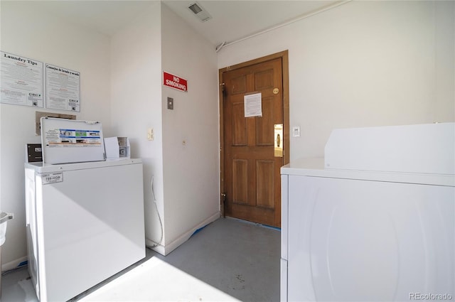 clothes washing area featuring washer and clothes dryer