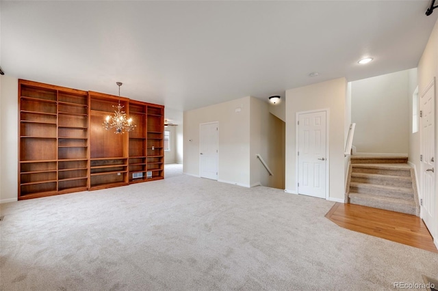 22813 E Briarwood Pl, Aurora, CO 80016 - unfurnished living room featuring carpet flooring and a chandelier