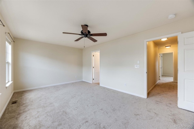 22813 E Briarwood Pl, Aurora, CO 80016 - empty room with a smoke detector, light carpet, a ceiling fan, and healthy amount of natural light