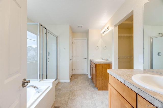 22813 E Briarwood Pl, Aurora, CO 80016 - full bath with a shower stall, two vanities, a garden tub, and tile patterned flooring
