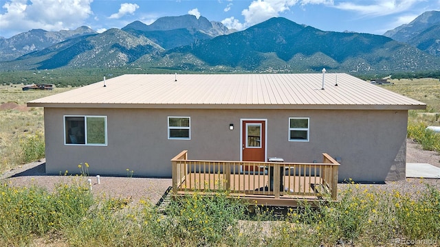 rear view of house featuring a deck with mountain view