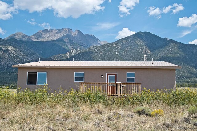 view of home's exterior featuring a deck with mountain view