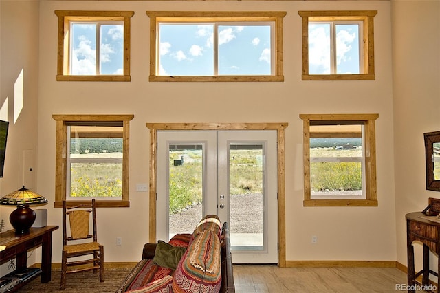 interior space with light hardwood / wood-style floors and french doors