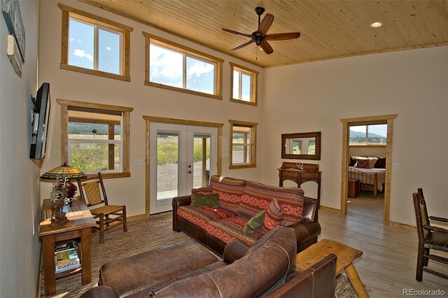 living room with ceiling fan, french doors, hardwood / wood-style floors, and wooden ceiling