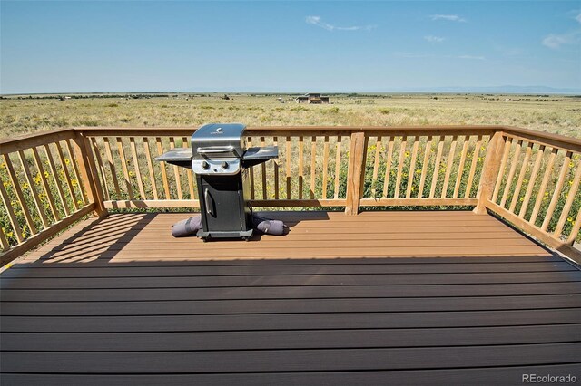 wooden deck with a grill