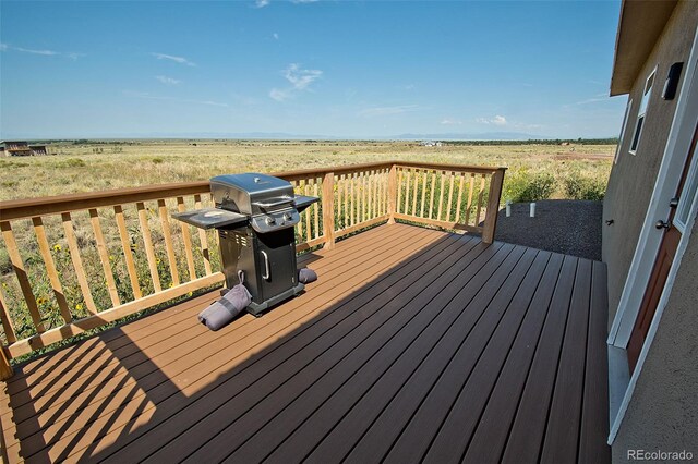 deck featuring a rural view and a grill