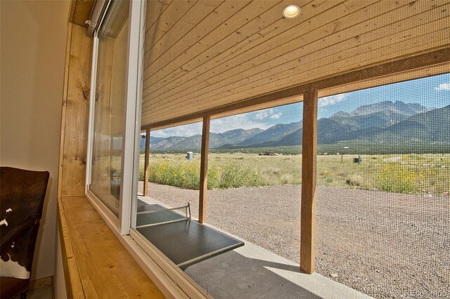 doorway to outside featuring a mountain view and wood ceiling