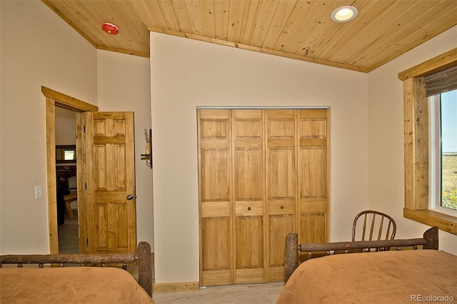 bedroom with a closet, wooden ceiling, and vaulted ceiling