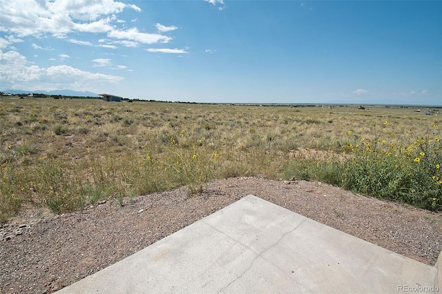 view of yard with a rural view