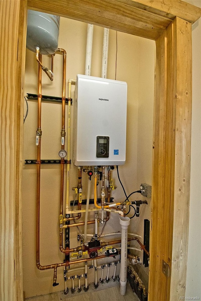 utility room with tankless water heater