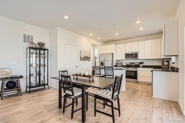 dining area featuring light hardwood / wood-style flooring and sink