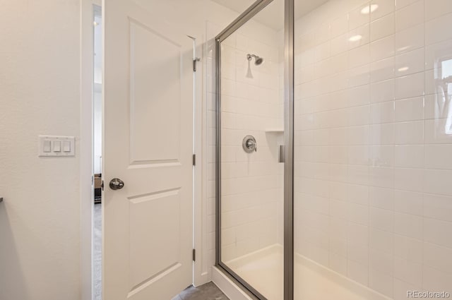 bathroom with a shower with door