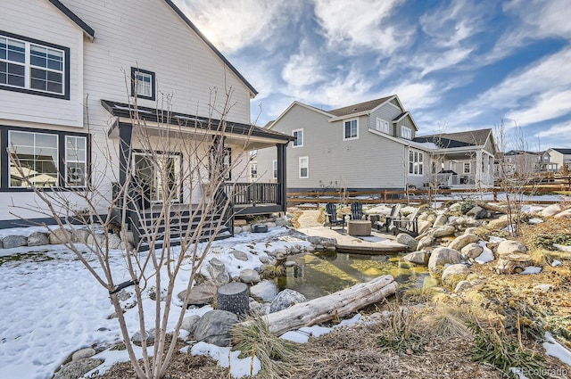 view of snow covered rear of property