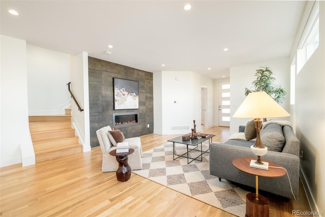 living room featuring a fireplace and light wood-type flooring